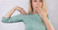 woman in green shirt embarrassed of her sweaty armpits