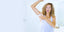 woman with curly blonde hair using sweatblock clinical wipes for excessive sweating