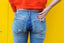 woman in jeans sweating how to stop bum sweat on chairs