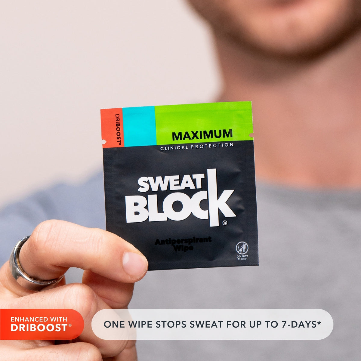 Man holding antiperspirant wipe that stops sweat for 7 days per application